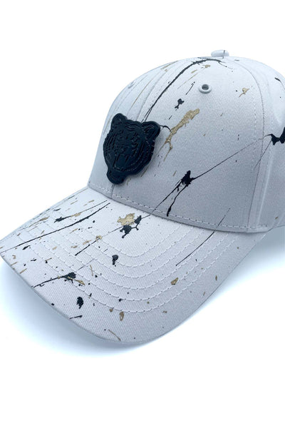 White cap with black and gold paint