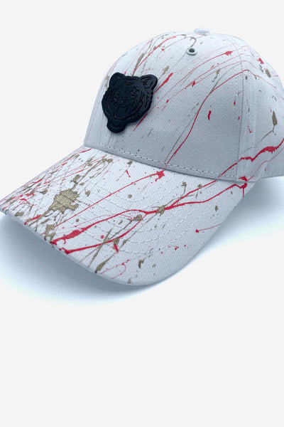 White cap with red and gold paint